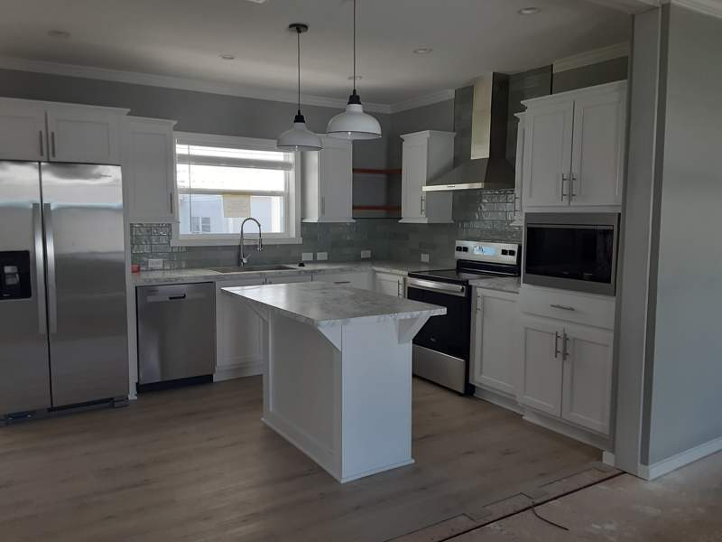 Open Kitchen featuring stainless steel appliances and serving bar.